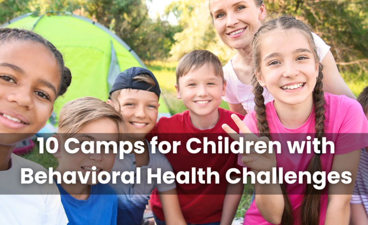 A group of children at a camp smiling in front of a tent